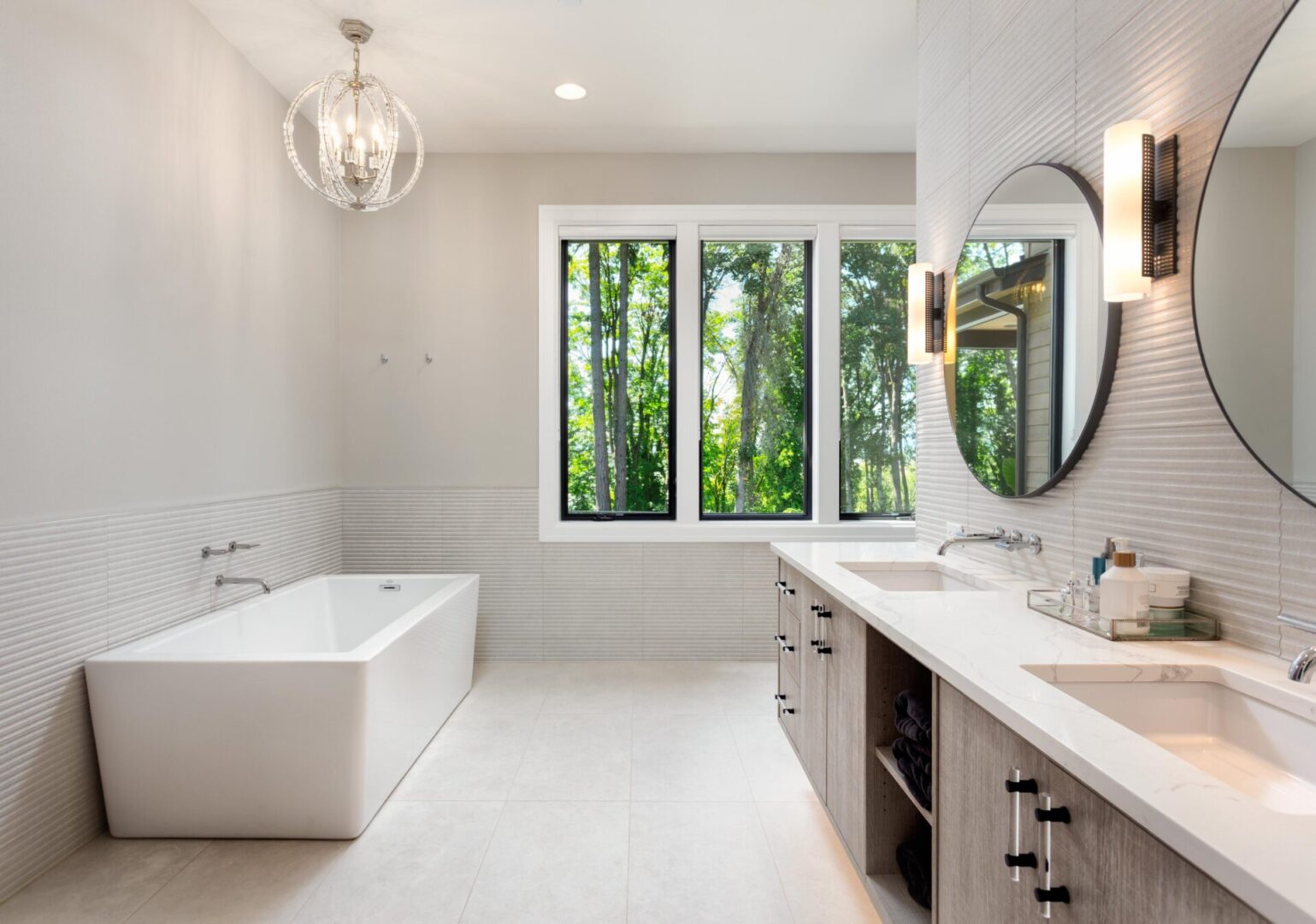 Modern bathroom with large tub and mirrors.